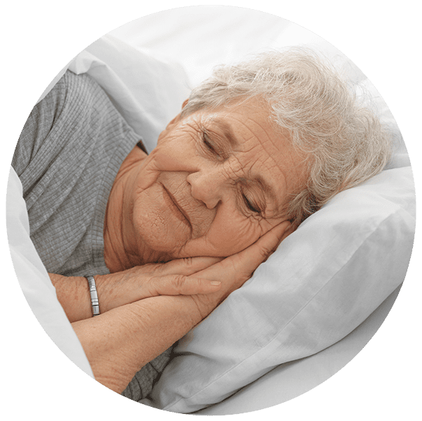A senior woman sleeping soundly in a bed