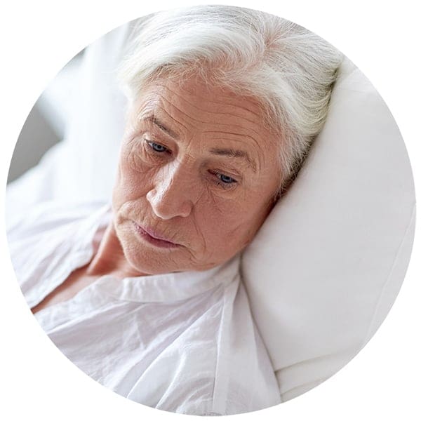 A senior patient in a hospital bed