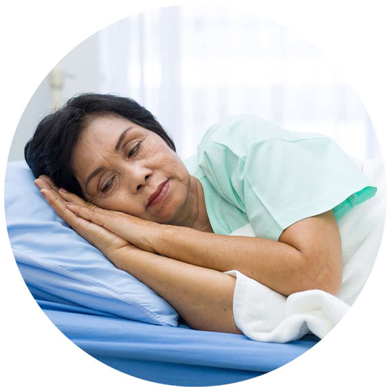 A senior woman resting in a hospital bed