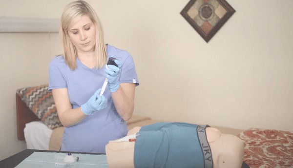 A nurse demonstrating how the Macy Catheter works in an instructional video