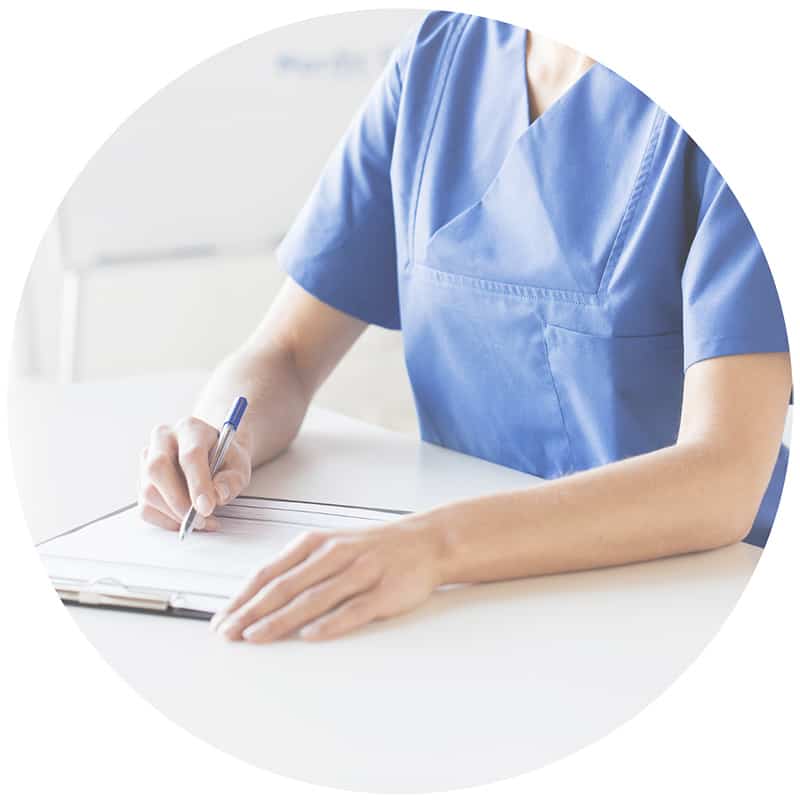 A nurse writing on a clipboard